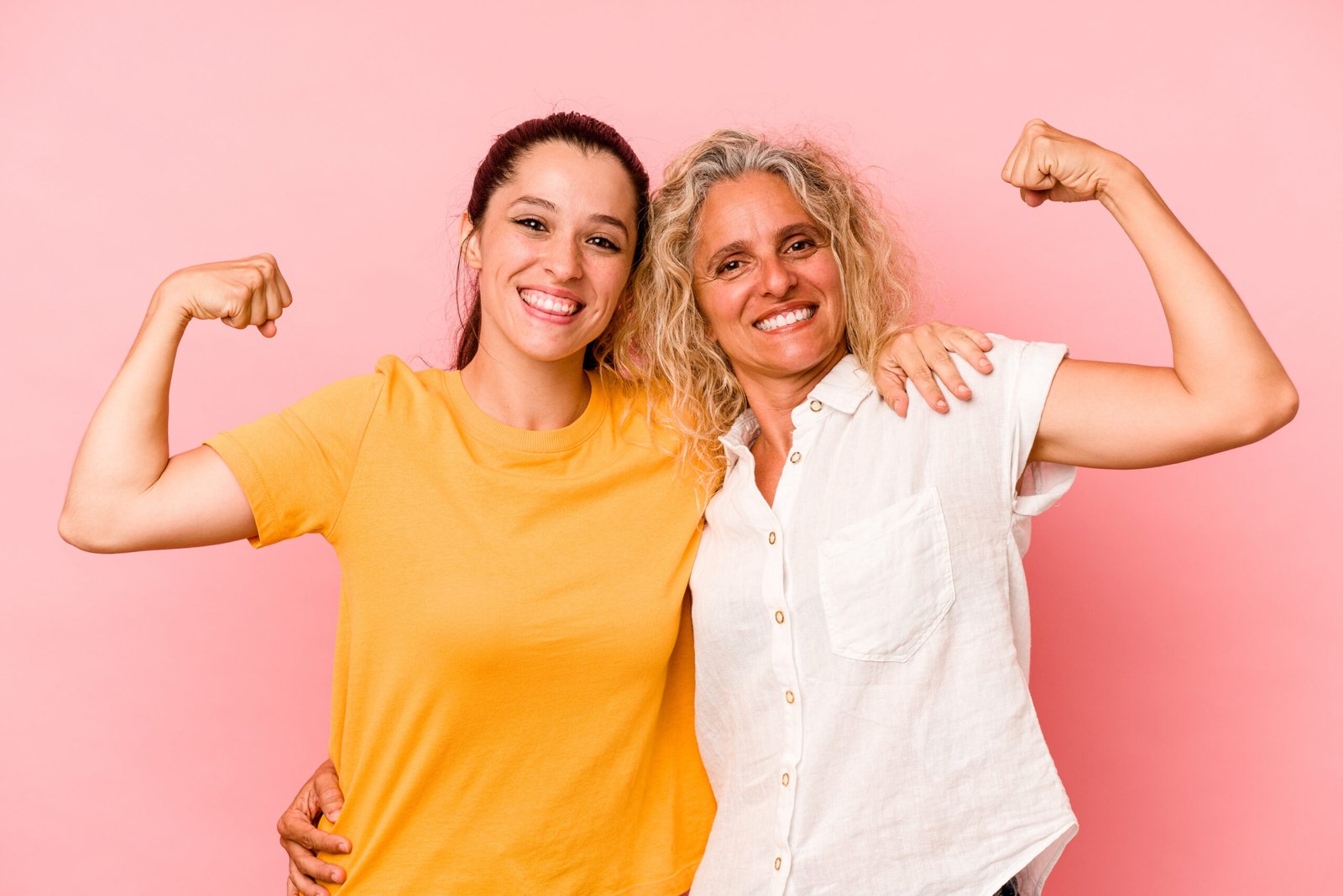 Caucasian mom and daughter isolated on pink background